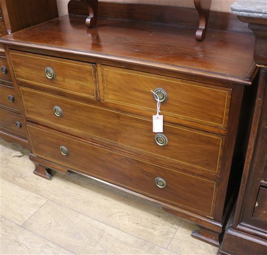 An Edwardian inlaid mahogany chest of two long and two short drawers and an inlaid mahogany dressing table W.107cm and W.114cm